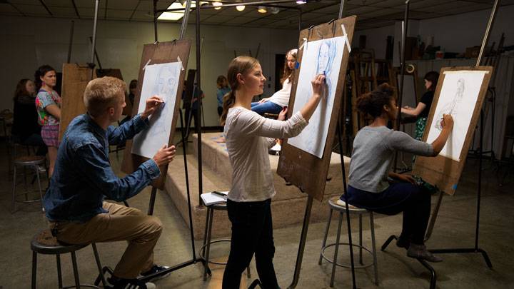 Students in art studio doing figure drawing