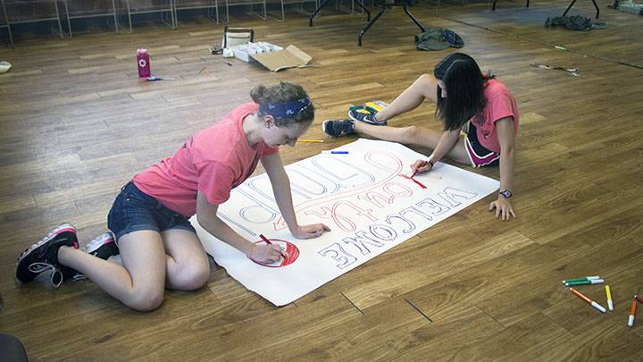 Students drawing poster for local church event