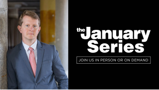 A man in suit and tie leans against a wall (left); the January Series logo (right)