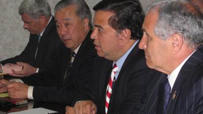 Tony Namkung sits in a meeting with other diplomats.
