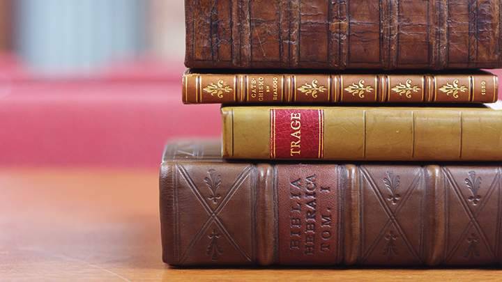 Four, very old leather-bound books from the Meeter Center's library.