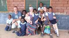 Dana Krol ’14, Dave ’11 and Jill Honderd Draayer ’13 at The Esther School in Chongwe, Zambia