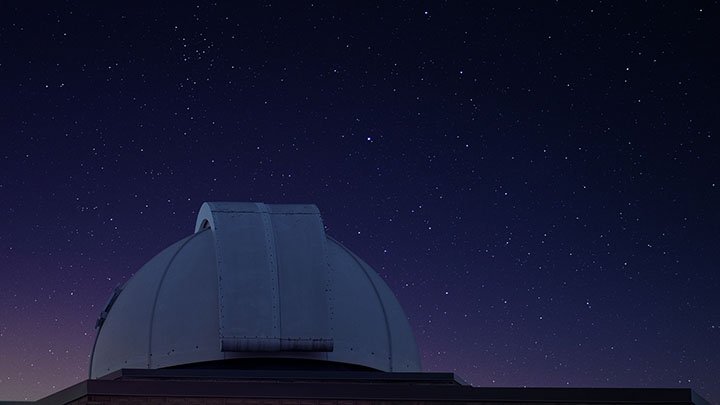 Image of the top of the Calvin Observatory with the night sky in the background