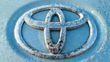 The Toyota logo with frost on it.