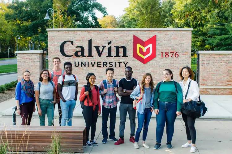 Group of students standing in front of Calvin sign