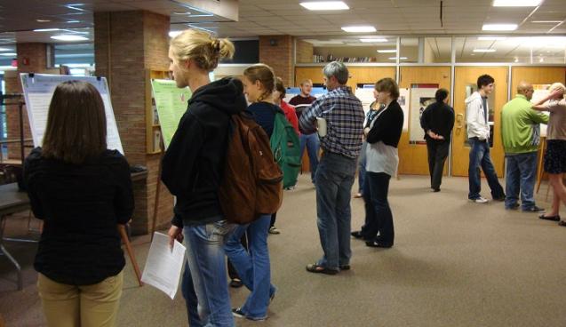 Students viewing posters at CMS 151 Poster session.