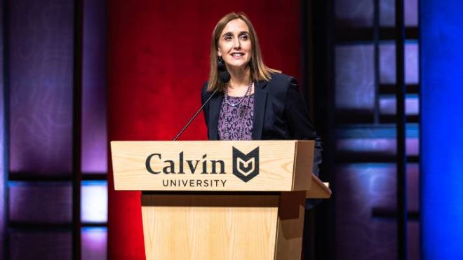 A woman stands behind a Calvin University wooden podium during the January Series.