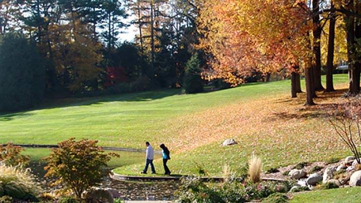 Students walking safely by the Seminary Pond on a fall day