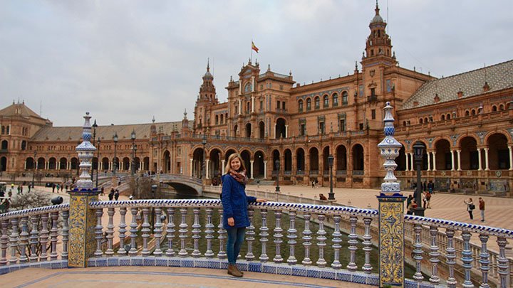 A student stands in front of a landmark in Spain.