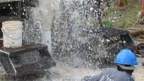 Water gushing from a new well in a development hydrogeology project