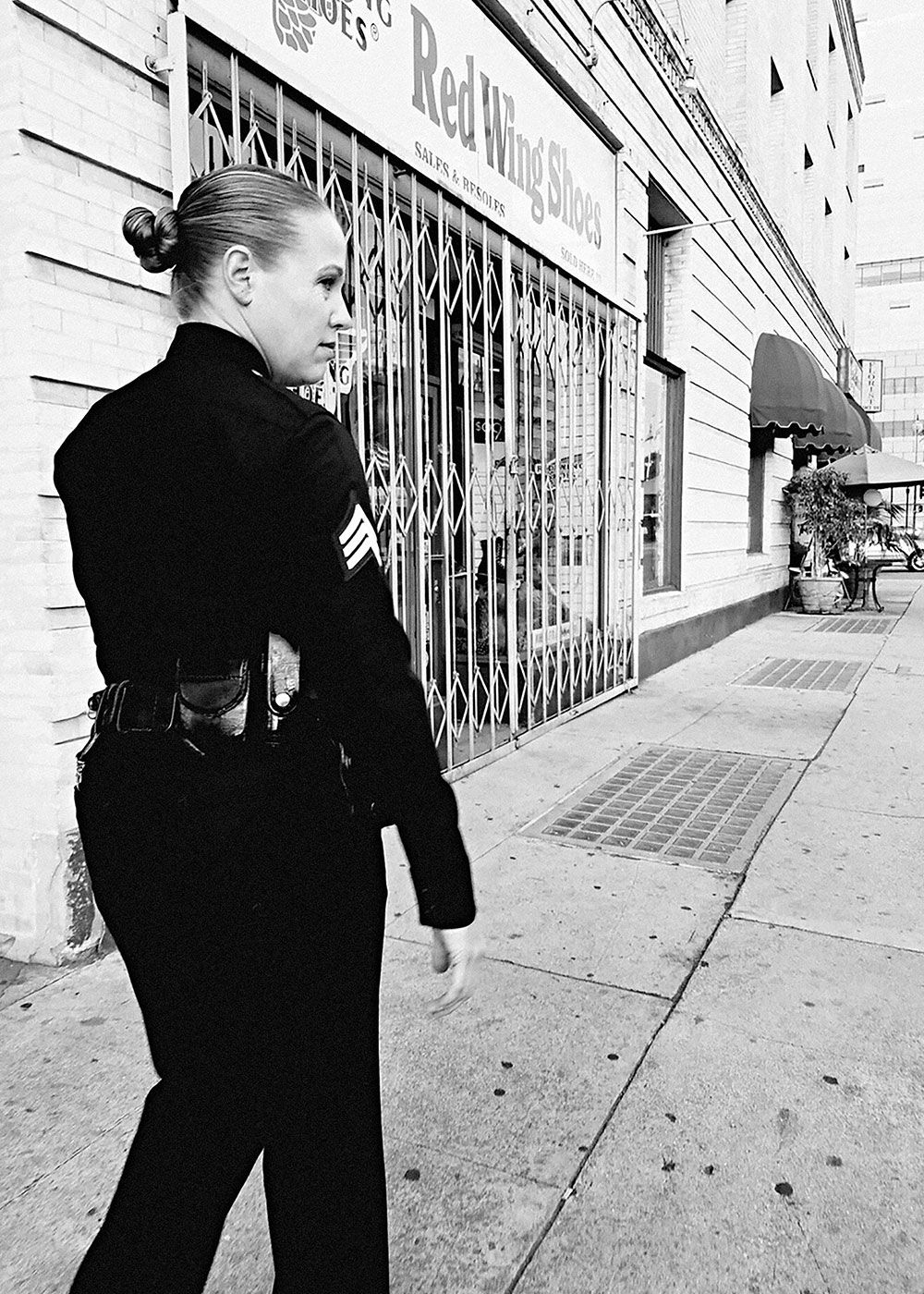 Dana Grant, in uniform, walking along city streets.