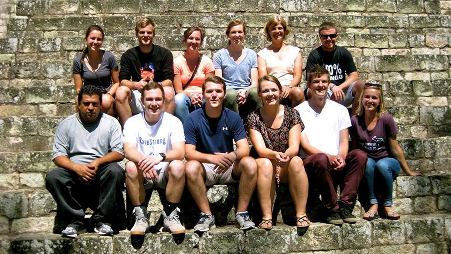 Calvin students on the semester program in Honduras pose for a picture on stone steps.