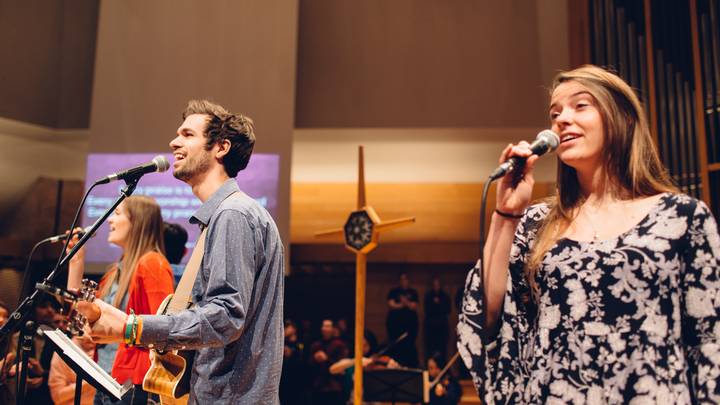 Male and female worship apprentices lead worship