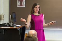 Female professor giving a lecture in front of a classroom