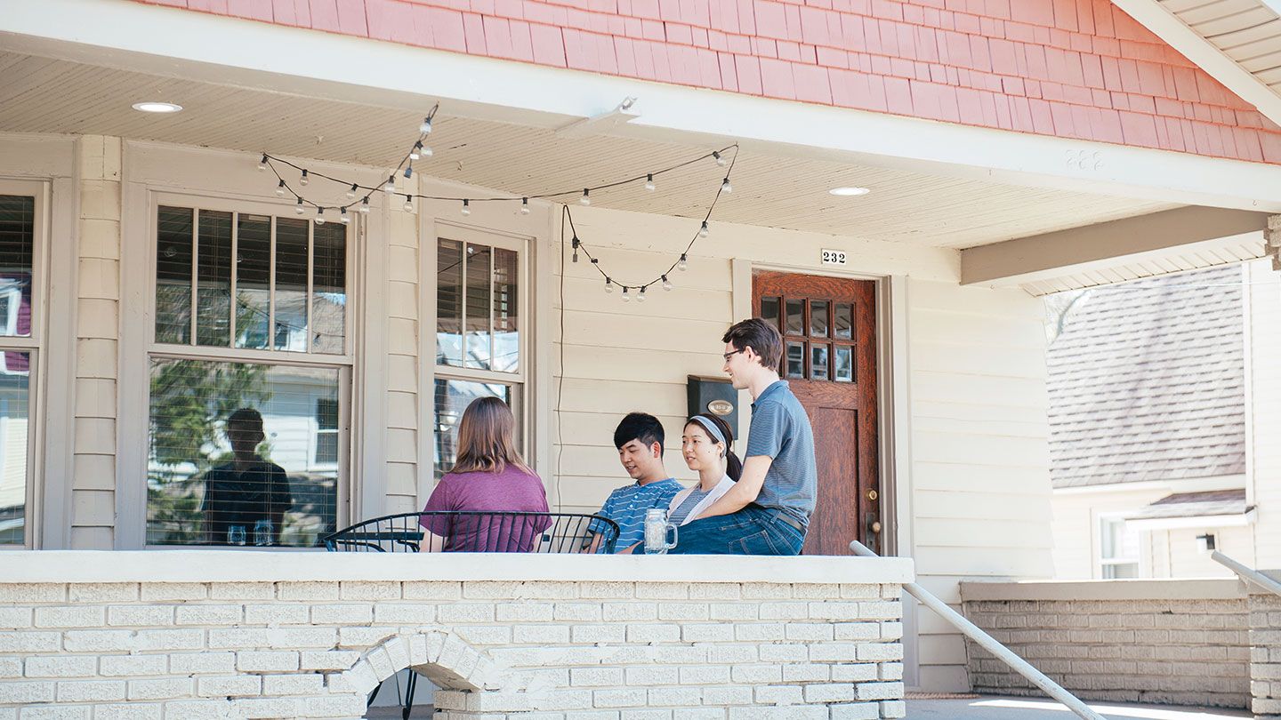 Noah Schumerth sitting on the porch of his Project Neighborhood house