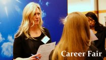 recruiter speaking with a student at a career fair
