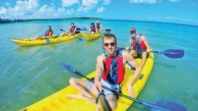 Garrett Bazany and friends kayaking in beautiful clear water.