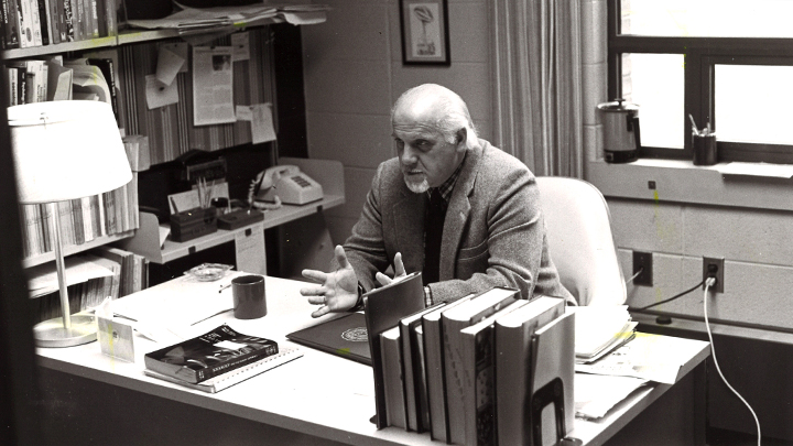 Professor Gordon DeBlaey seated at his desk.
