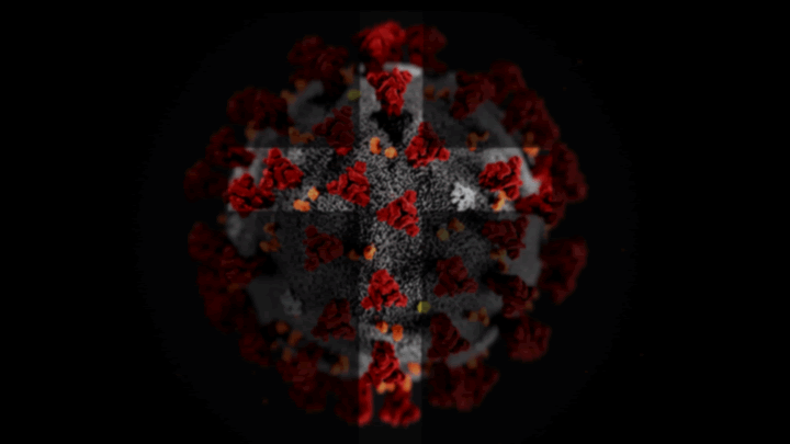 A cross shape illuminates a visual of the coronavirus.