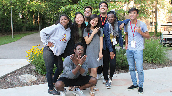 A group of students pose for the camera on a summer day on Calvin's campus.