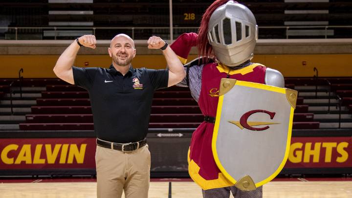 Head football coach Trent Figg poses with Joust, the Calvin University mascot.