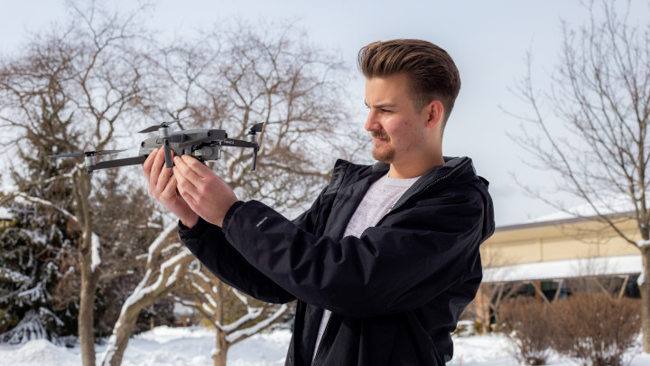 Adam Tjoelker examines a drone