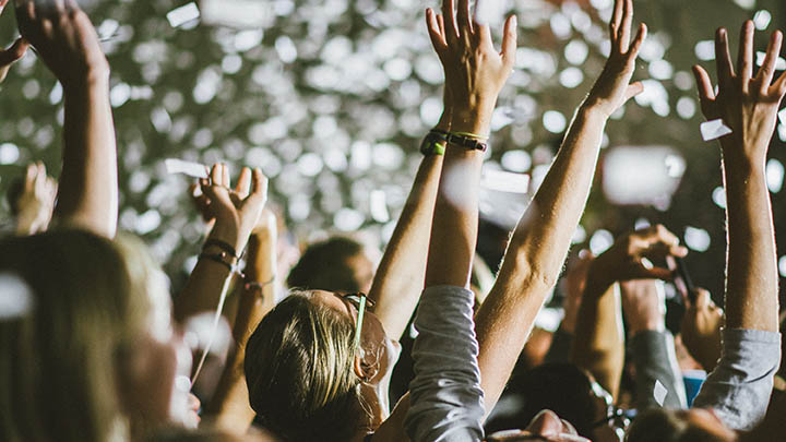 Students' hands raised during a concert