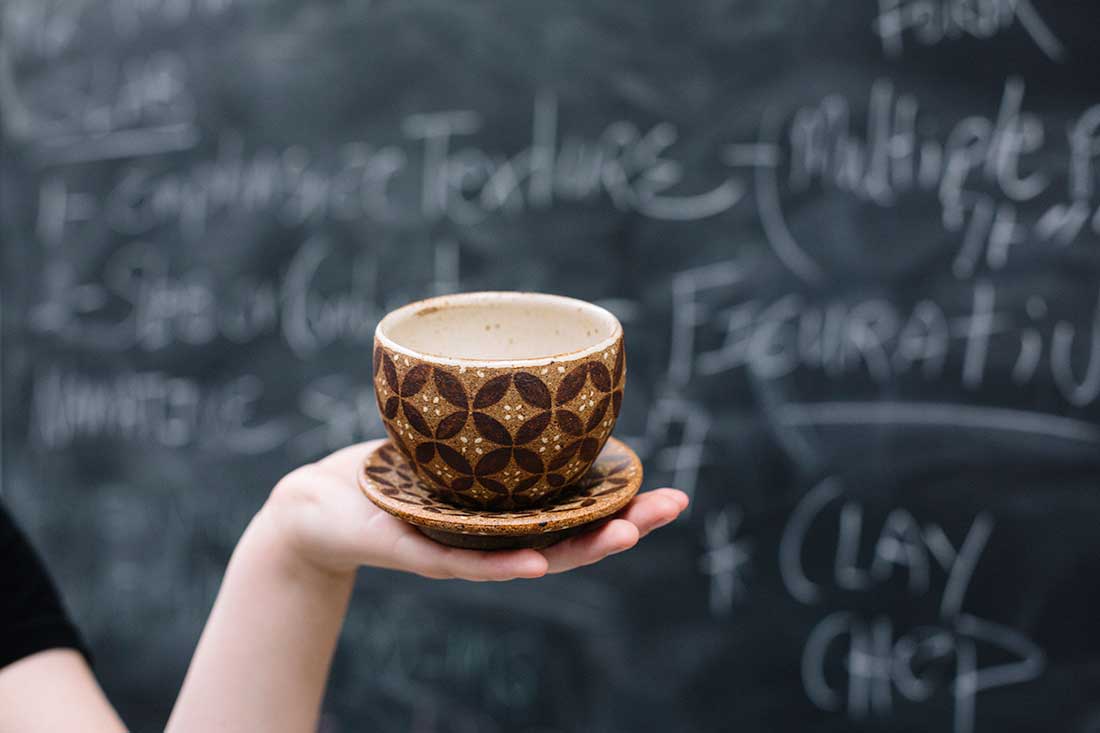 Batik Cup - Rebekah holding her clay masterpiece