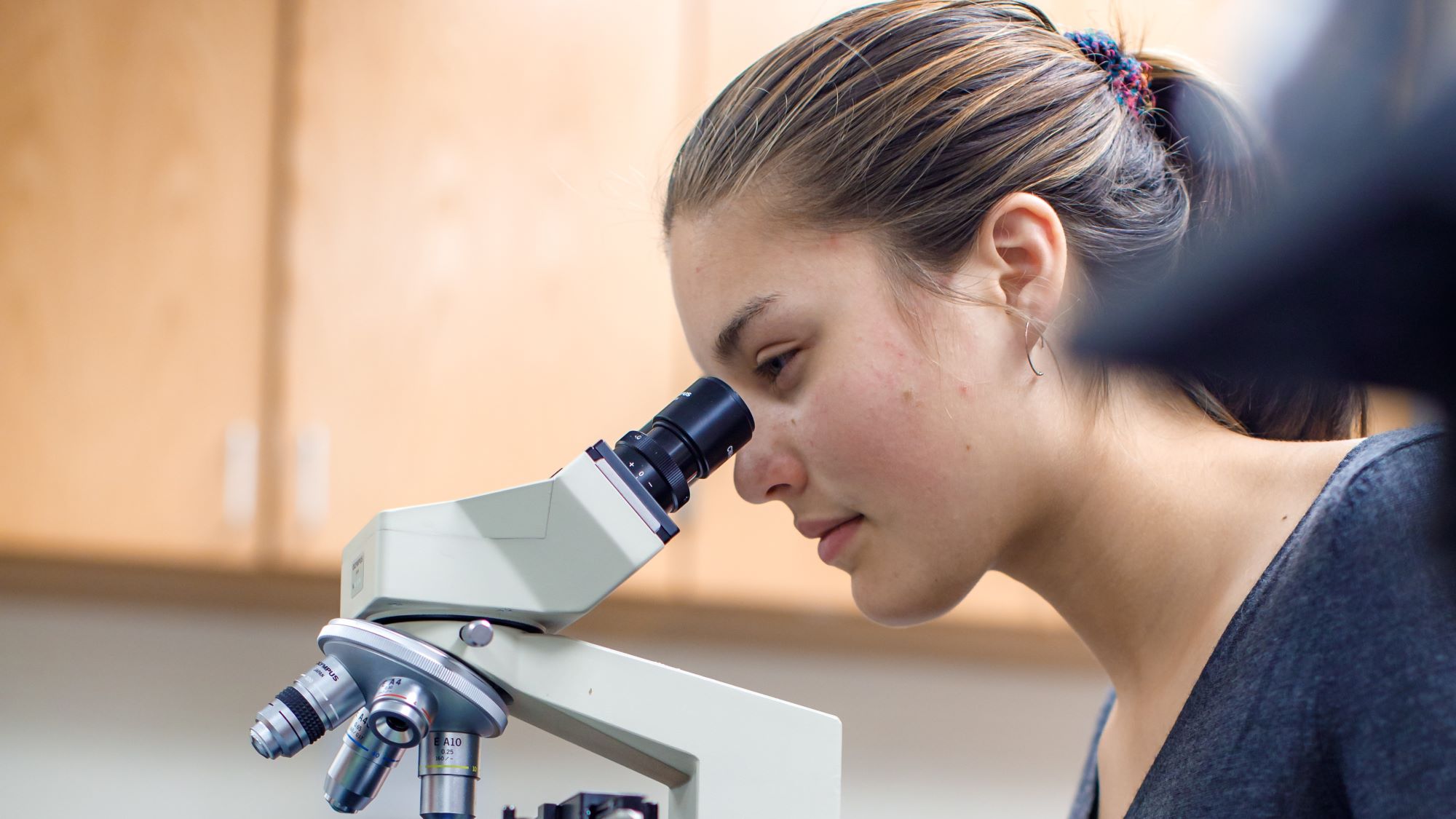 A female student using a microscope