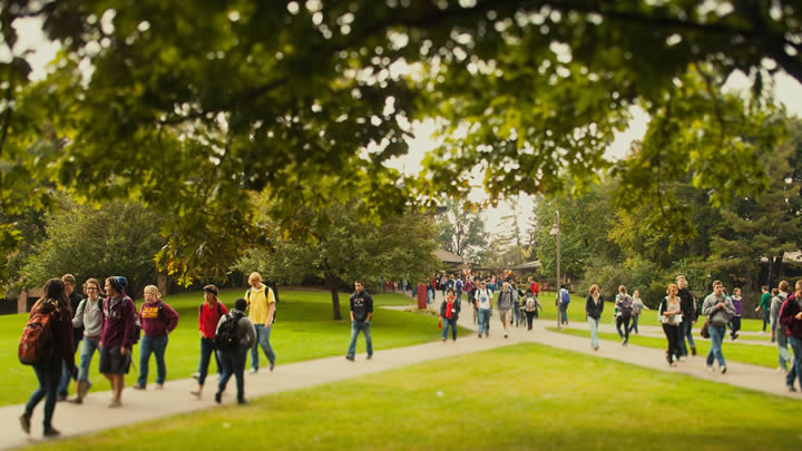 a photograph of students walking to and from classes on campus