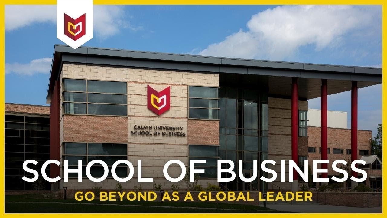View of the exterior of the school of Business, a brick building with large windows and three prominent red pillars.