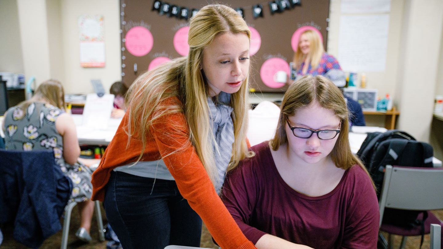 A student teacher working with a young learner