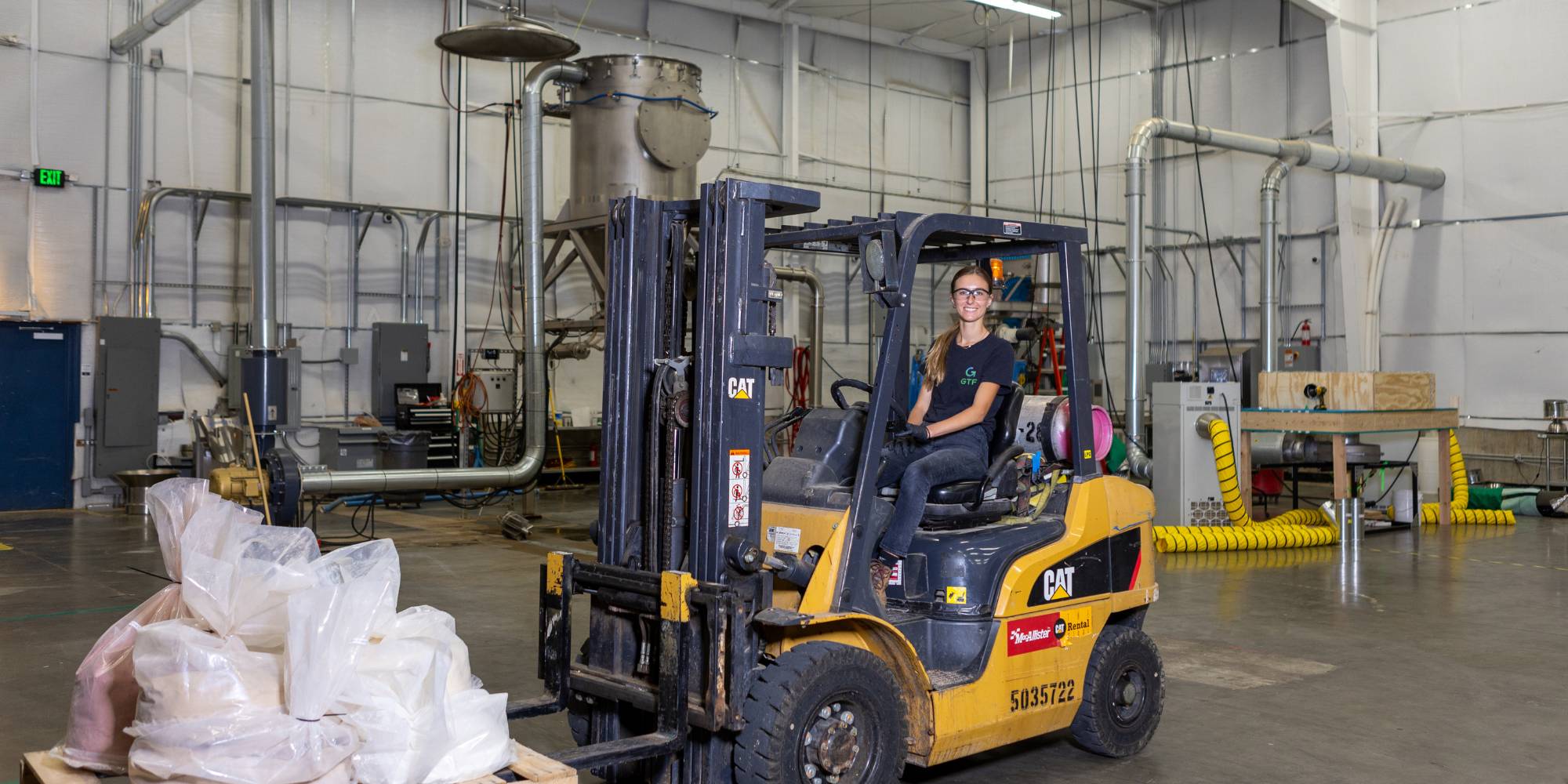 Student riding a forklift