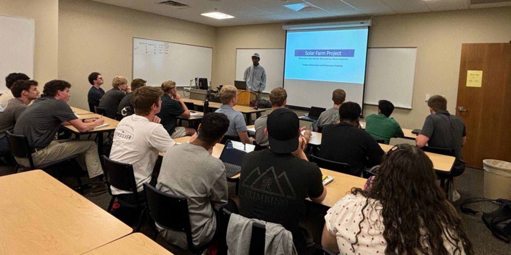 An engineering class listening to a student present.