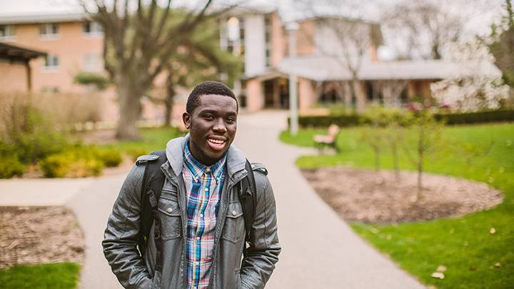 Student walking along a sidewalk