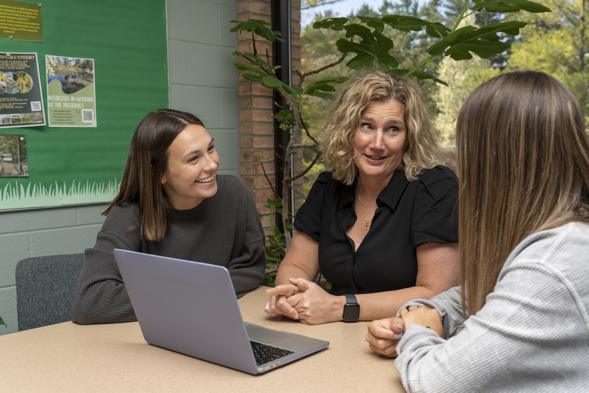 Three nursing students at a laptop