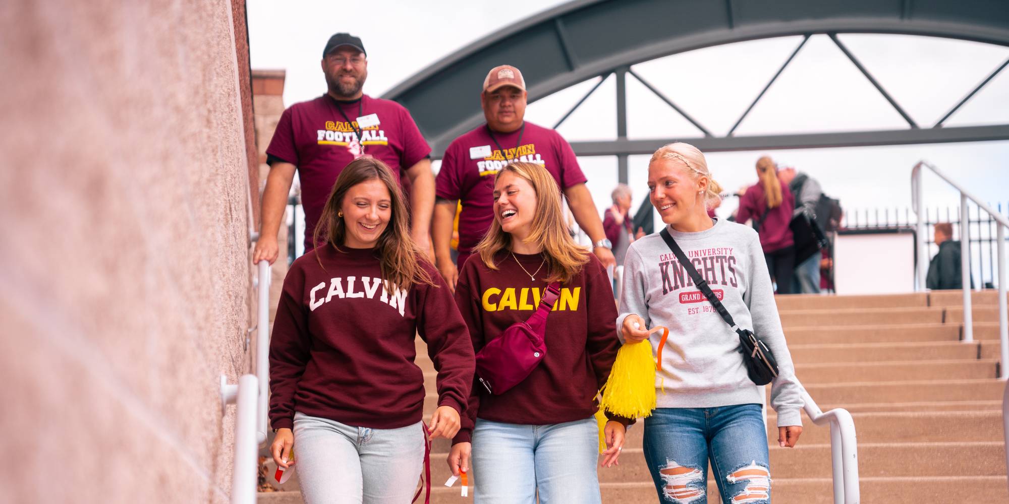 Calvin fans walk down the stairs toward the football field.