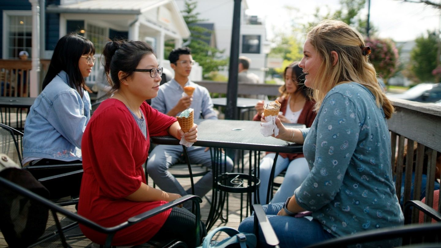 Two students at an outdoor table