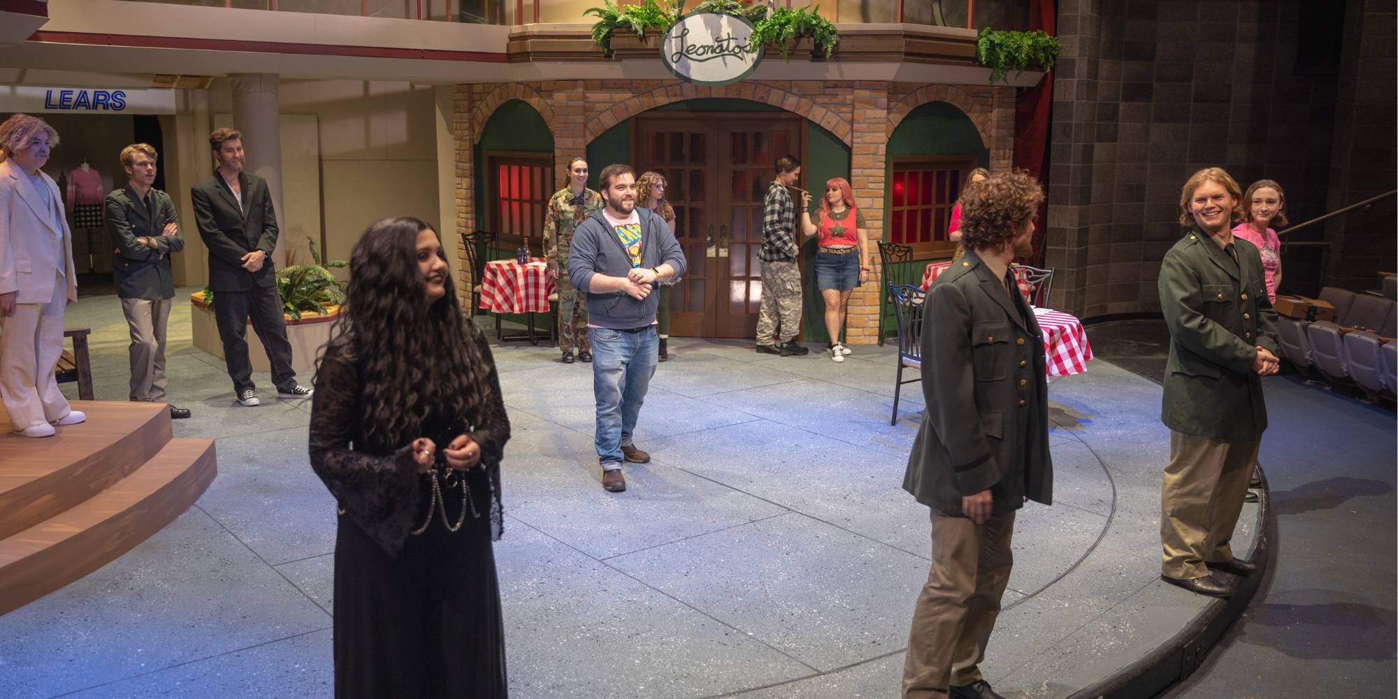 John Scritchfield (center) works with the cast on staging for the play "Much Ado About Nothing."