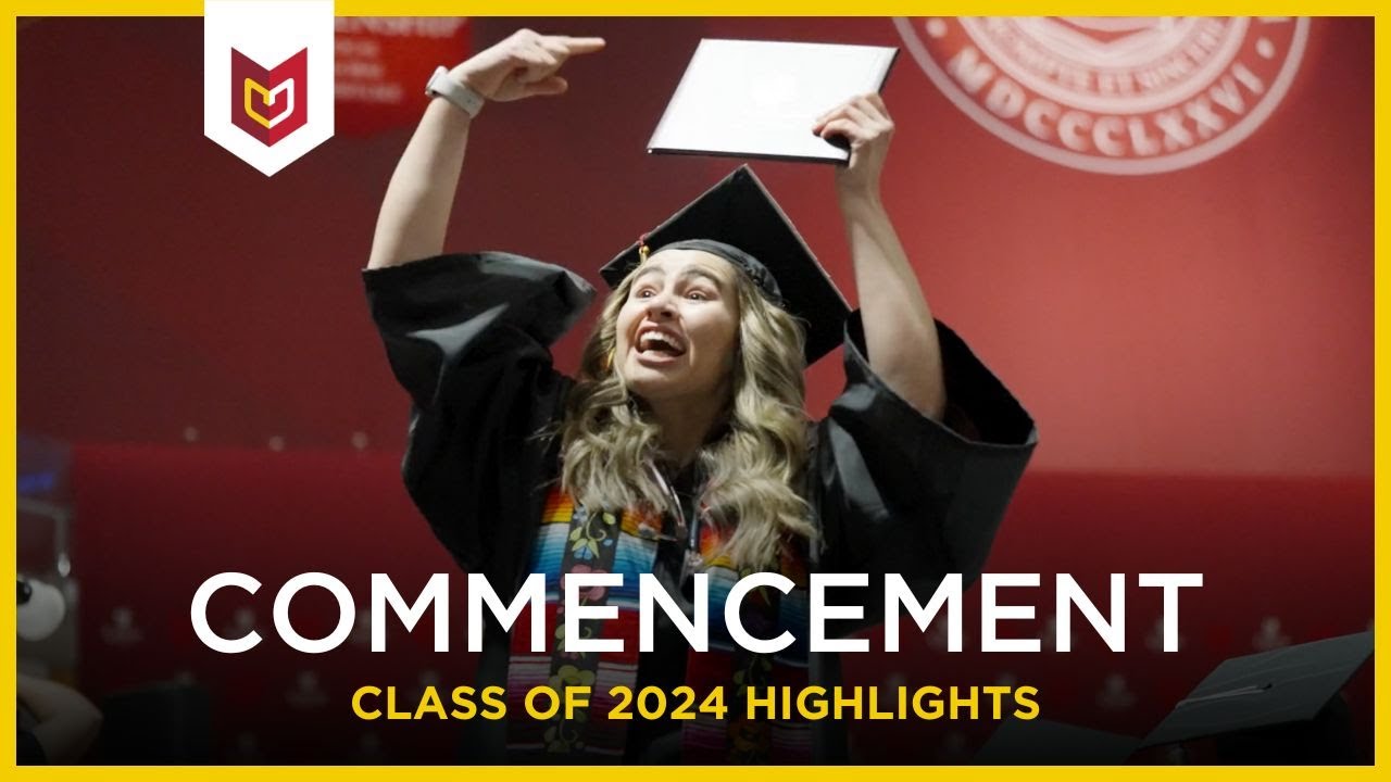 A female Calvin University graduate cheers with her diploma in the air at commencement.