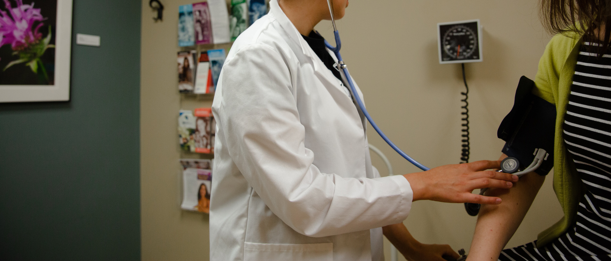 A nurse takes the blood pressure of a patient.