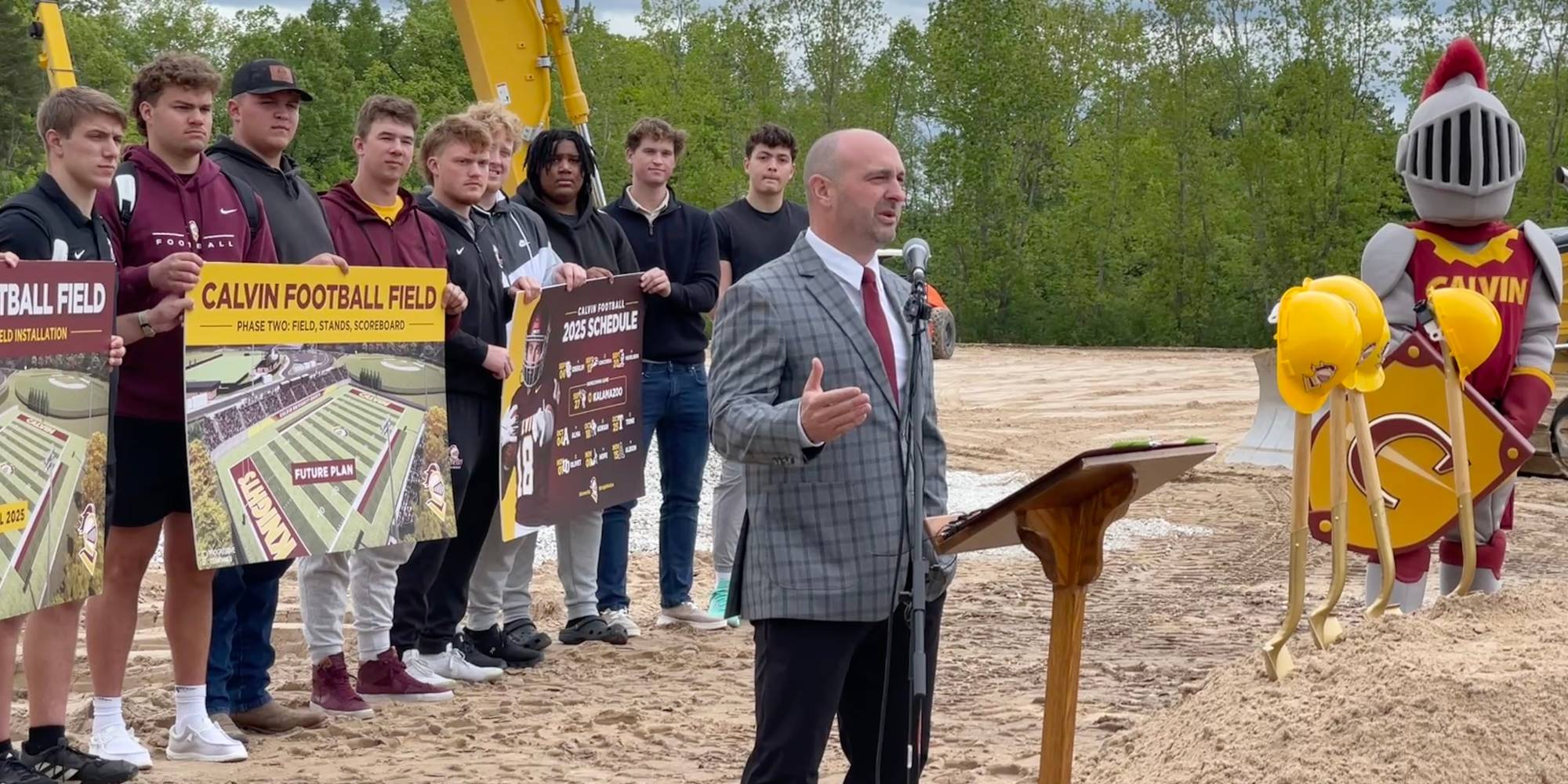 Trent Figg, head football coach at Calvin University, speaks during groundbreaking ceremony for football field.