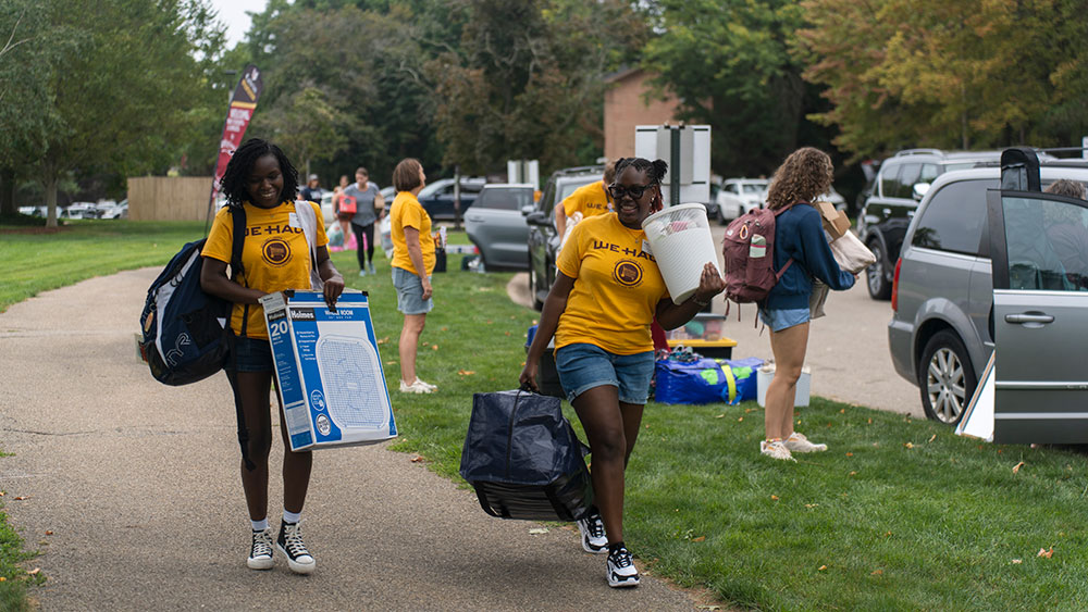 Calvin students helping new students move into the dorms