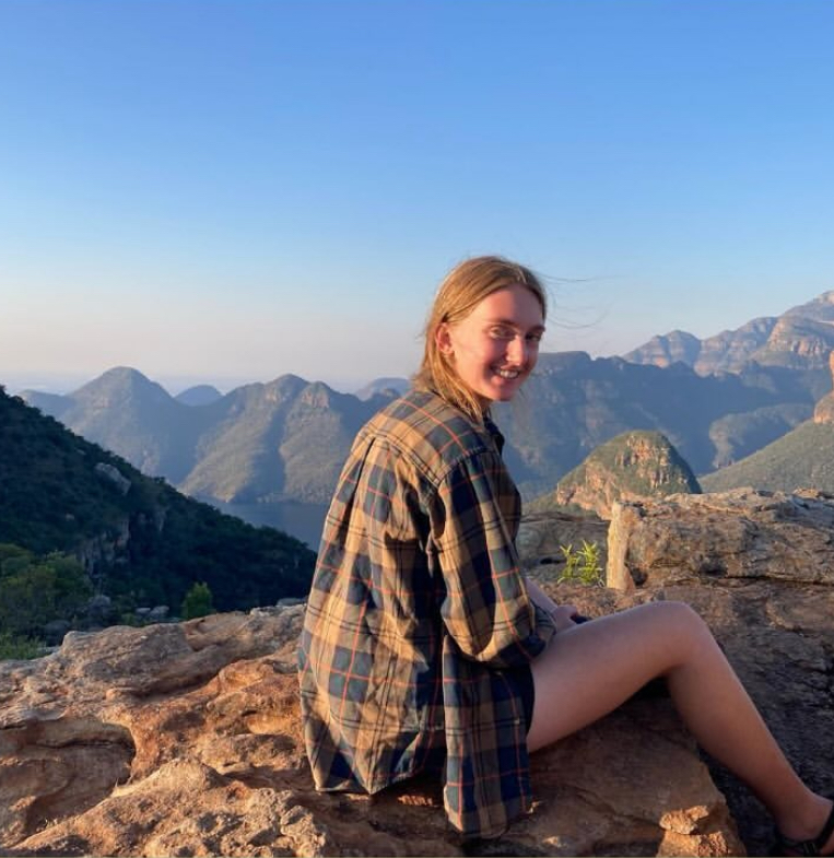 Girl smiling near mountains 