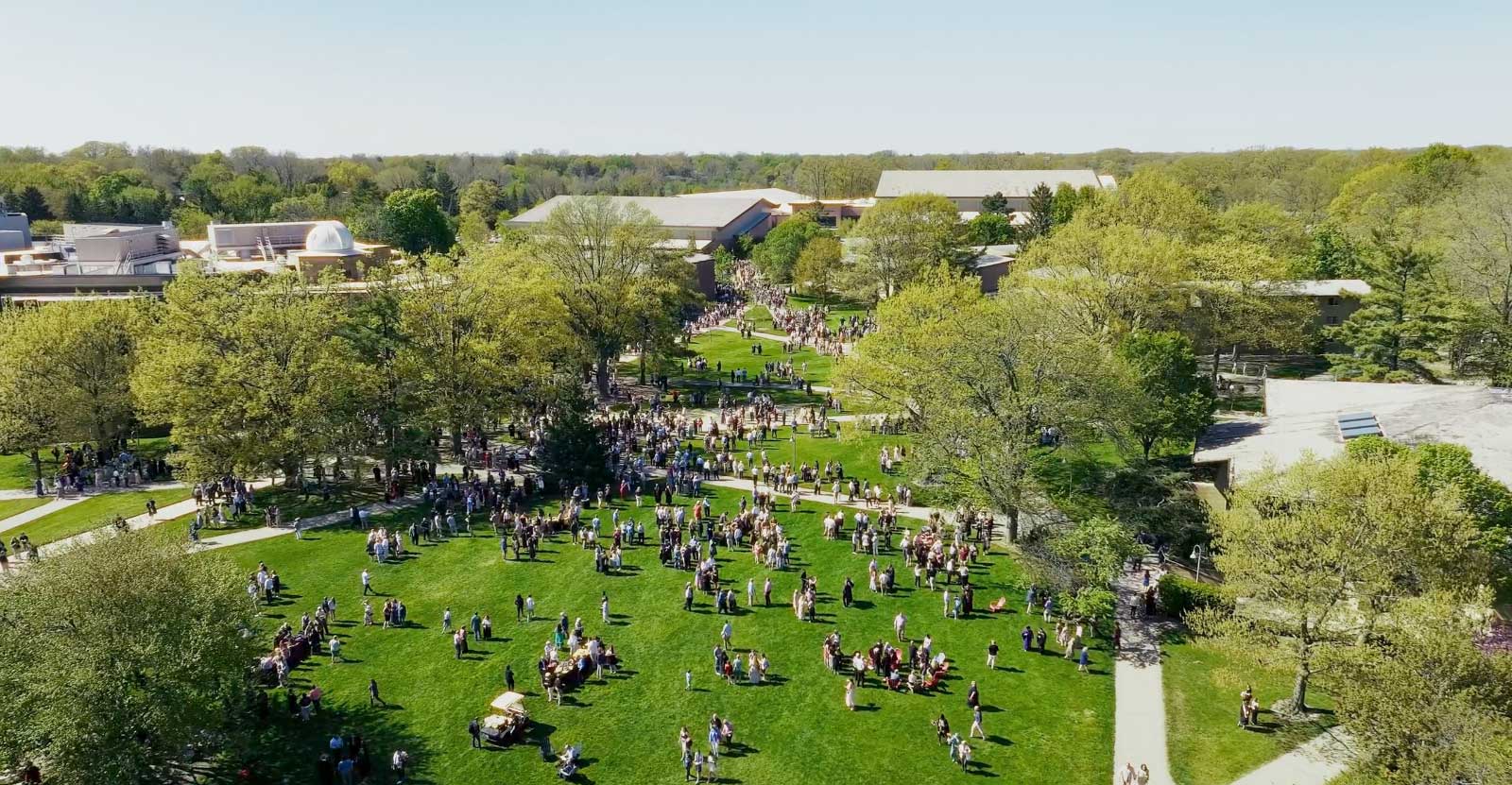 The Rooted and Reaching illustration over an image of the East Beltine and the Calvin Crossing bridge over it.
