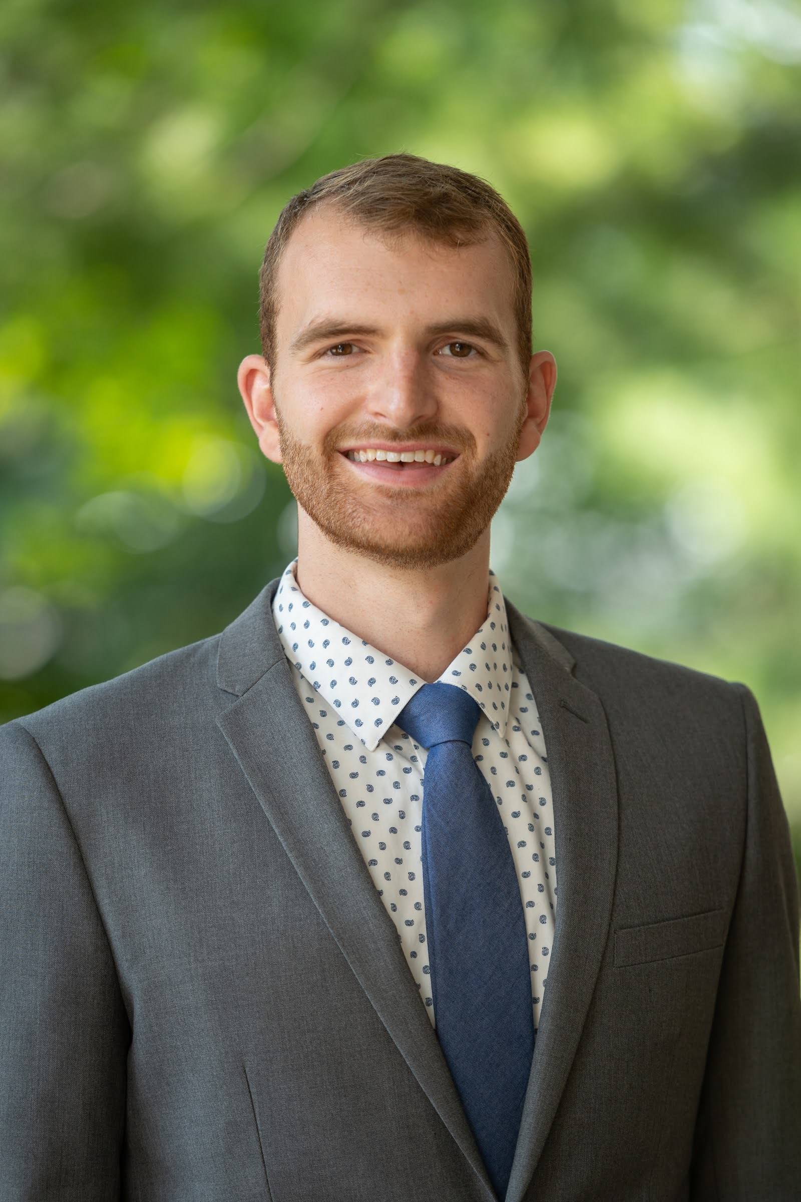 Tanner Vincent in a gray suit with a blue tie