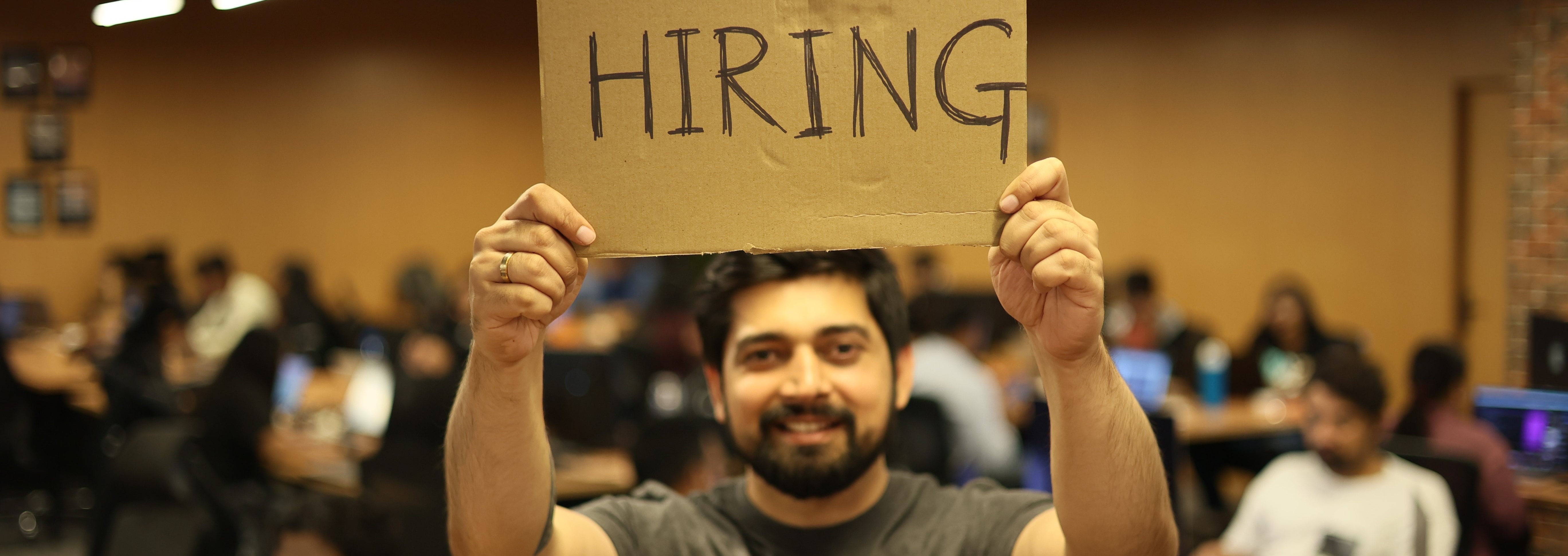 Man holding hiring sign