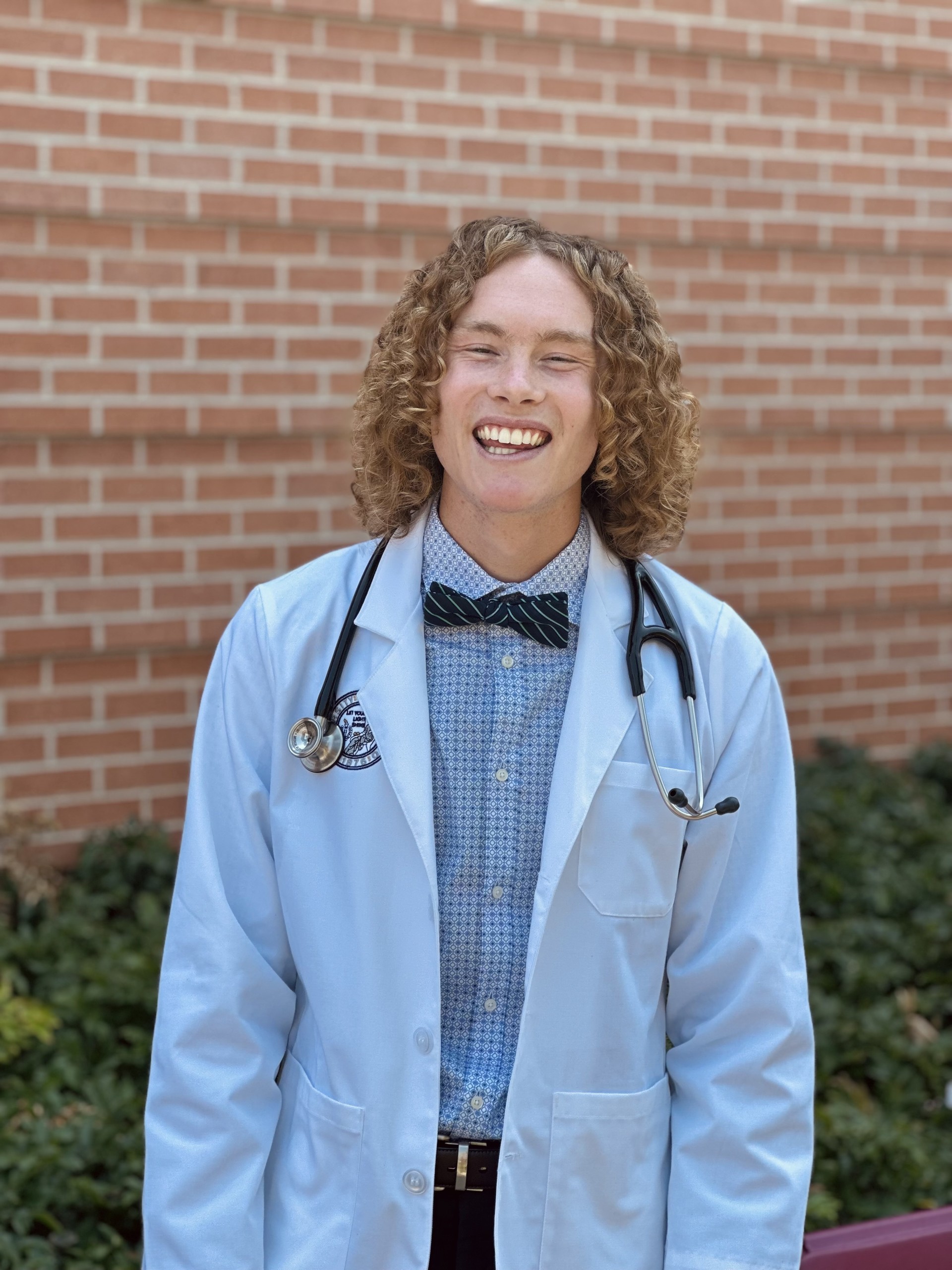 Photo of Jesse McCurdy. He has long curly hair and is a white male. 