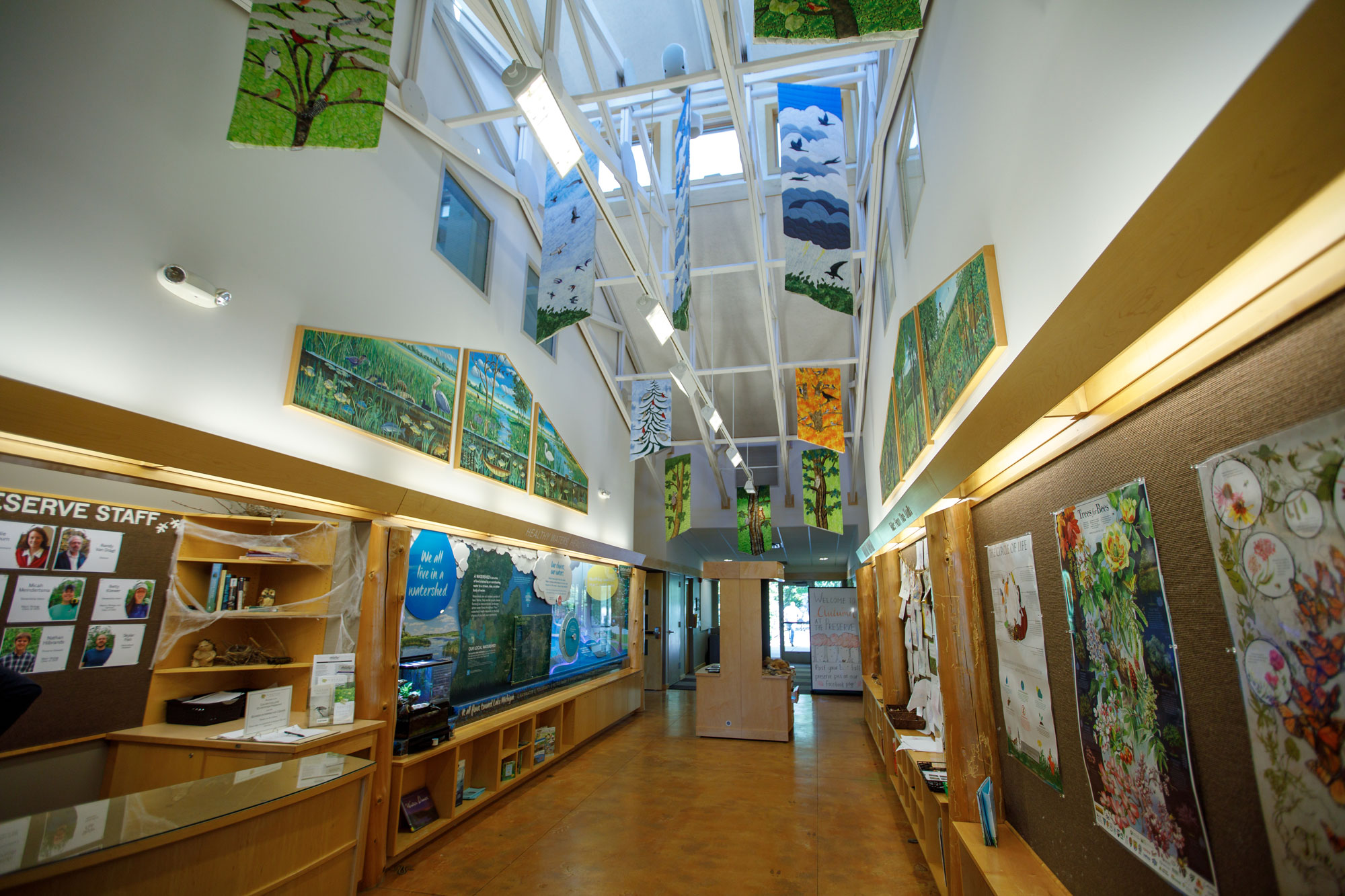 The Bunker Interpretive Center with colorful banners hanging from the ceiling and posters on the walls depciting local flora and fauna.