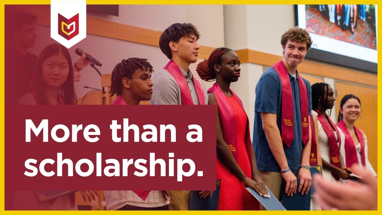 A diverse group of students lines up on stage in graduation tassels, holding certificates.